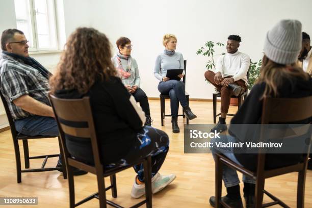Group Therapy Support Meeting Talking About Their Mental Health Stock Photo - Download Image Now