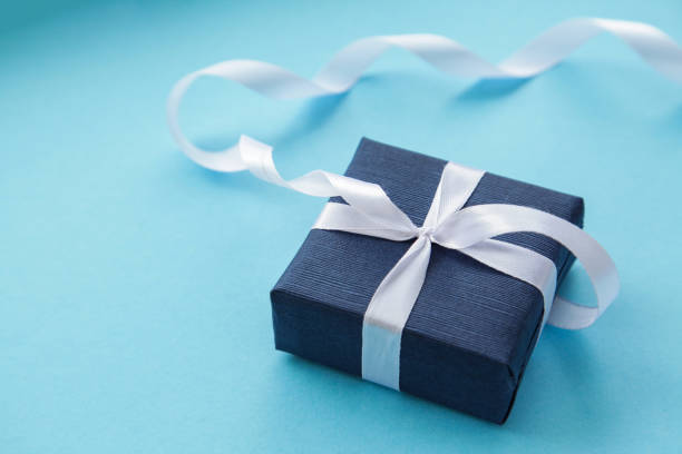 istock Dark Blue Gift box on light blue background. Gift for men. Fathers day. Present for him. 1308950786