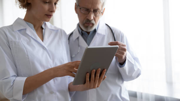 istock Diverse doctors cooperate on tablet in clinic 1308951097