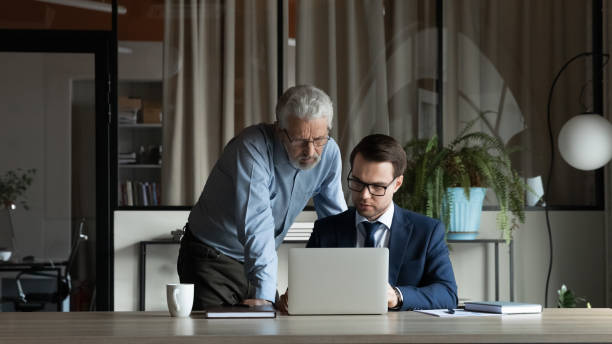 istock Diverse male employees brainstorm working at laptop 1308954321