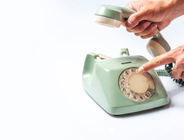 istock Calling with Vintage Telephone on White Board 1308955207