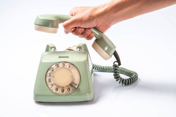 istock Calling with Vintage Telephone on White Board 1308955211