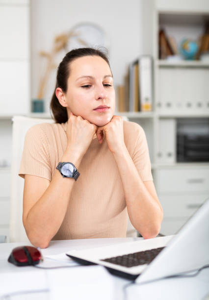 istock Tired businesswoman working with documents in office at table 1308955301
