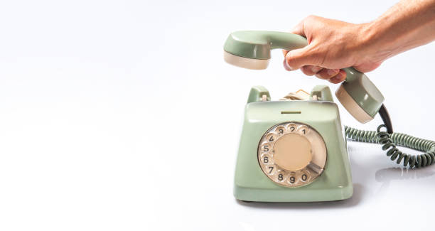 istock Calling with Vintage Telephone on White Board 1308955365