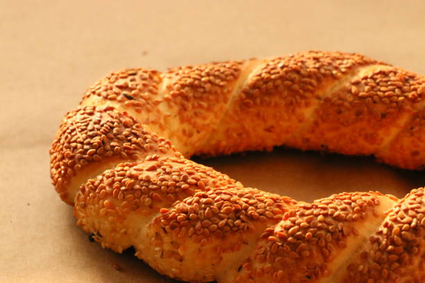 istock Turkish crispy bagel with sesame seeds on brown wrapping paper 1308955608