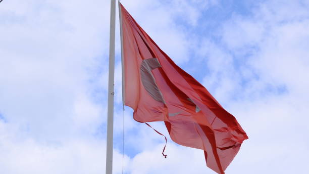 istock Huge turkish flag with overcast cloudy sky 1308959228