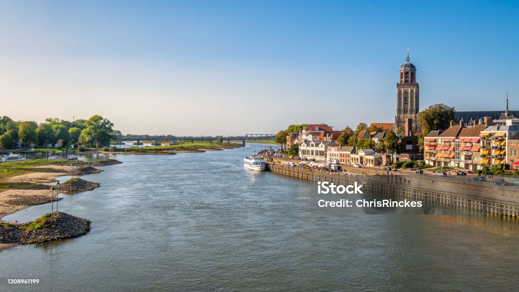 River IJssel and the Dutch Hanze city of Deventer (Netherlands) Sunset at the gorgeous Dutch Hanze city of Deventer. It's located along the IJssel River and is situated in the eastern part of The Netherlands. The  Great Church or St. Lebuinus Church can be seen Deventer Stock Photo