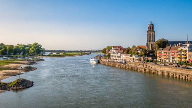 river ijssel and the dutch hanze city of deventer (netherlands) - grass church flood landscape imagens e fotografias de stock