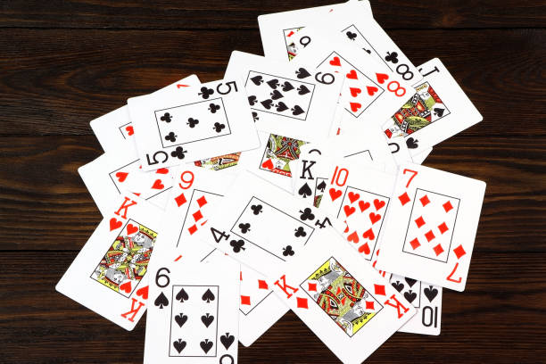 istock Playing cards for poker on a wooden table. 1308961310
