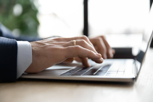 istock Close up businessman using laptop, typing, writing email or report 1308963250
