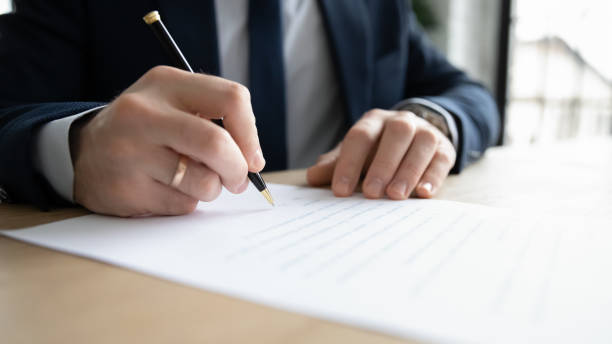 istock Close up business owner signing documents, making successful deal 1308963252