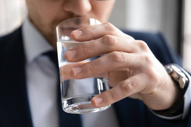 istock Close up confident businessman drinking fresh pure mineral water 1308963312