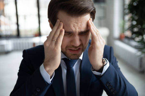 istock Close up stressed businessman touching temples, suffering from headache 1308963327