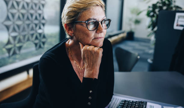 istock Businesswoman thinking in office 1308965123