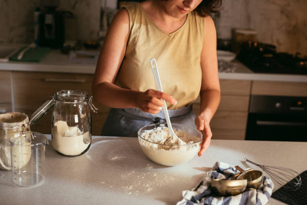 istock Kitchen Activities: a Young Woman Making Sourdough Bread at Home 1308966666
