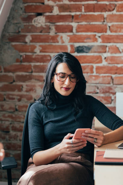 istock Young Businesswoman Using a Smartphone in the Office 1308967915