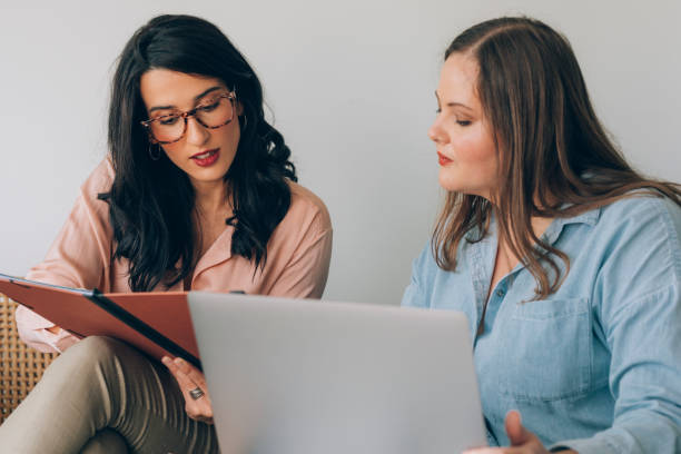 istock Two Young Businesswomen Working Together 1308967957