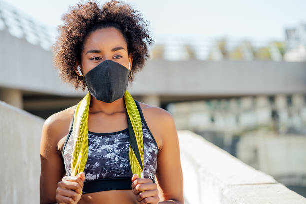 istock Afro athletic woman standing outdoors. 1308968564