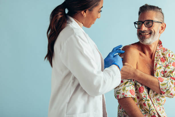 istock Doctor giving vaccination to mature man 1308968661