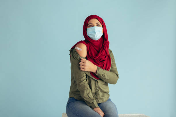 istock Vaccinated woman in face mask 1308968810