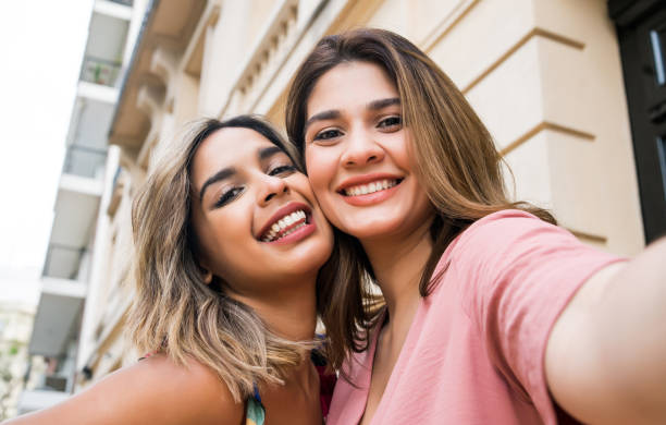 istock Two friends taking a selfie outdoors. 1308969093
