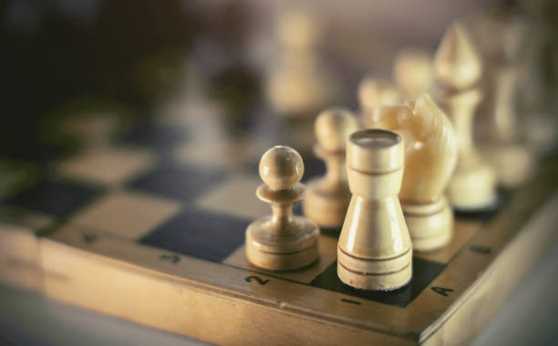 istock White's pieces on the chessboard, top view. 1308969792
