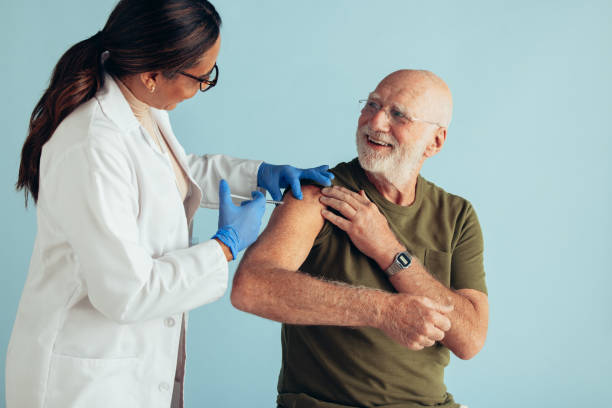 istock Doctor giving vaccination to elderly man 1308969794