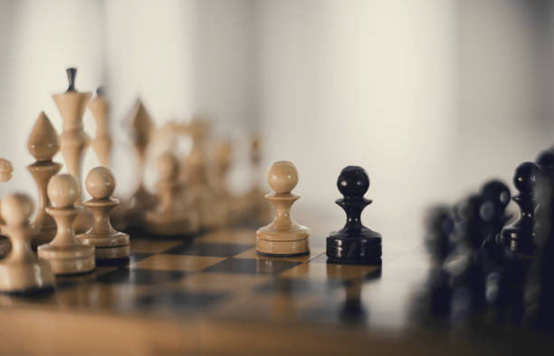 istock Two chess pieces are pawns: black and white. 1308969830