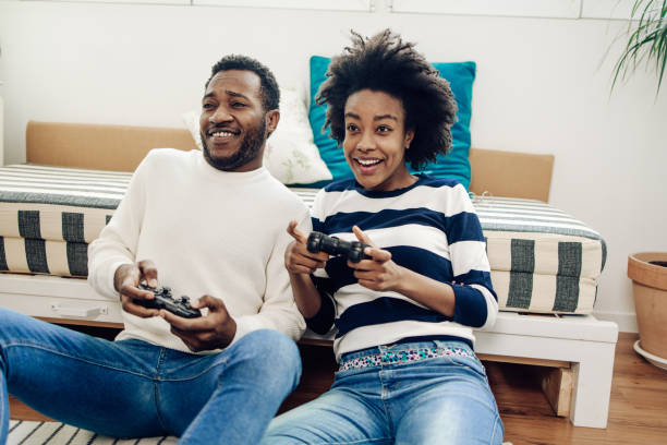 istock Happy African - American couple having fun gaming 1308969931