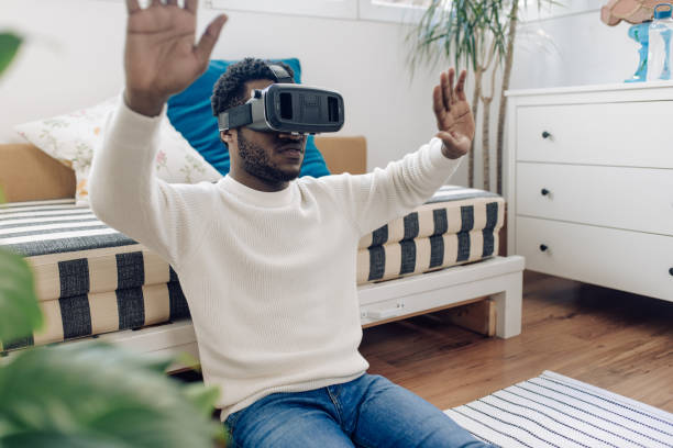 istock Portrait of a young African American using a virtual reality headset for gaming 1308970024