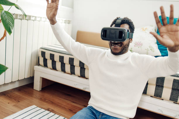 istock African American man  playing with a virtual reality headset at home 1308970029