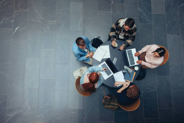 istock Young people studying together at college library 1308971398