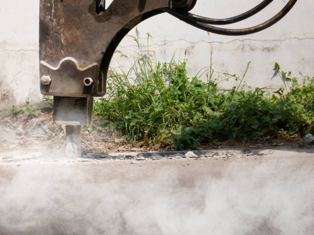 istock Machine is working to drill the concrete pavement Causing dust smoke and noise pollution The operation of the machine to drill the road 1308971729