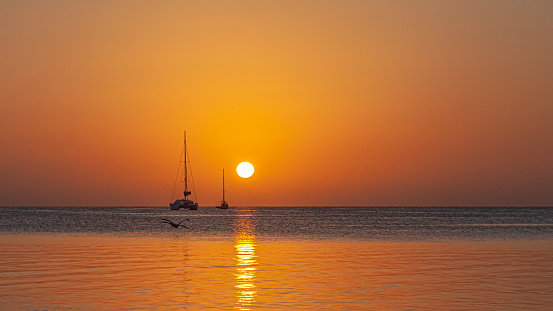 The sun sets over the Caribbean Sea in Belize.