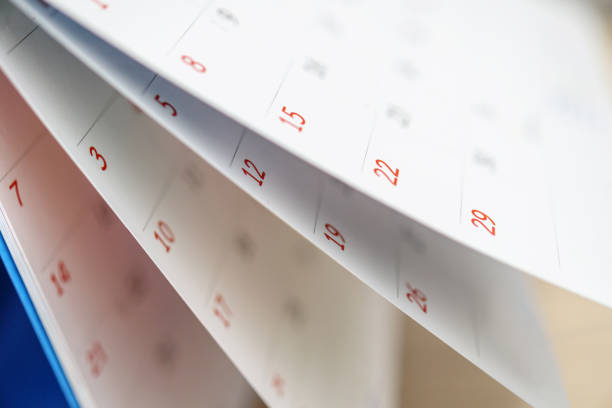 istock Calendar page flipping sheet close up on office table background business schedule planning appointment meeting concept 1308983662