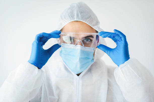 istock Young man in full protective costume and protective face mask. COVID 19 concept. 1308984052