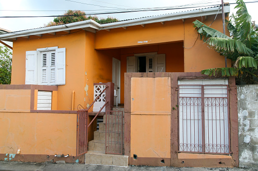 April 18, 2013 - St. Kitts. Run down house with metal fence in St. Kitts