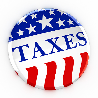 Taxes written on a red, white, and blue button