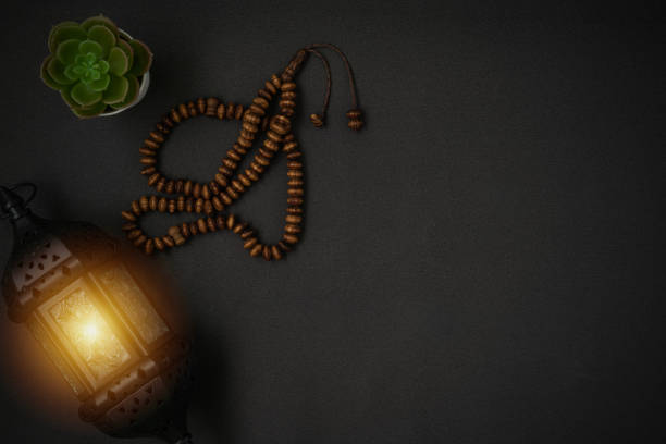 istock A stunning Ramadan candle lantern and rosary beads or tasbih on black background. Copy space. 1308987461