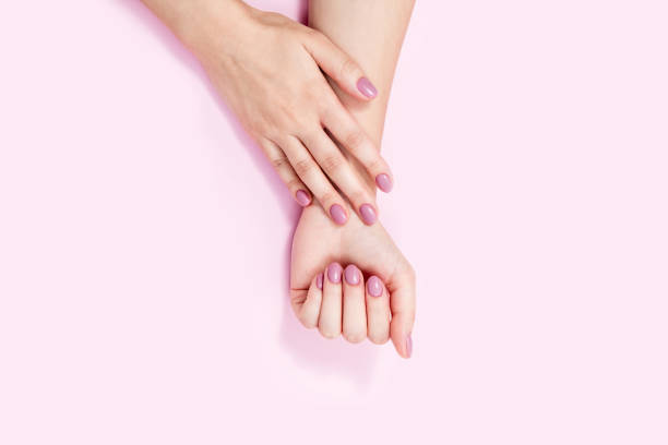 istock Beautiful female hands on a pink background. 1308989444