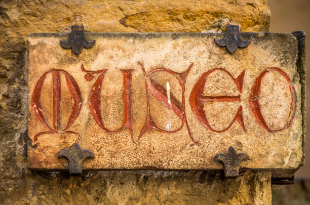 A gray concrete sign on a brick wall
