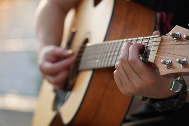 istock Practice playing guitar Beautiful woman playing guitar,close up 1308994239