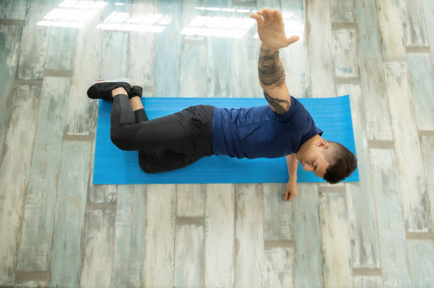 istock latin male athlete doing abdominal exercises at home 1308997476