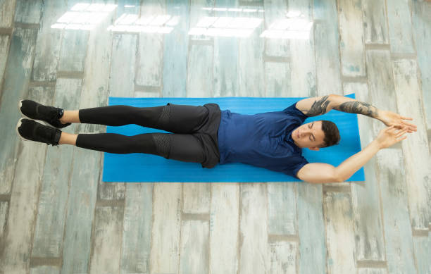 istock Young latin man doing abdominal exercise at home, aerial view 1308998041