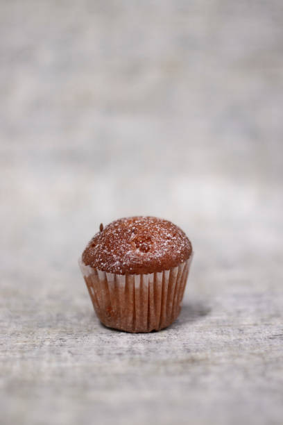 istock muffin cupcake covered in powdered sugar. bakery sweet 1308999780