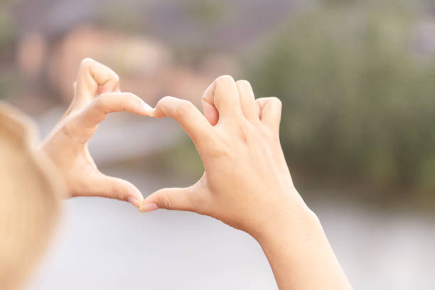 istock Closeup hand make heart shape with nature background, selective focus 1309007094