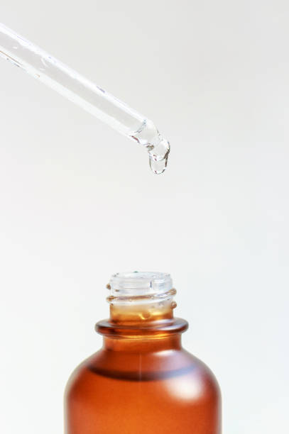 istock Bottle with serum and pipette on white background close-up. 1309008116