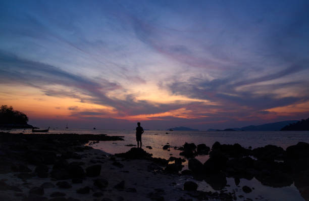 Scene of beautiful sunset at koh Lipe, Satun province and silhouette of a man on the beach