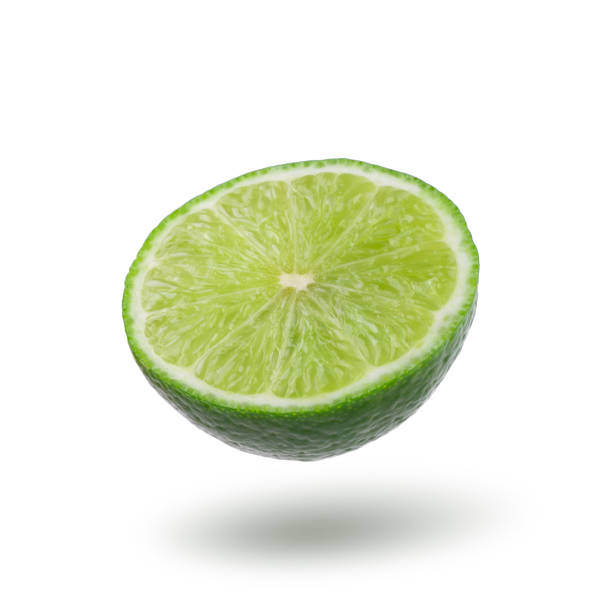 istock Half with slice of fresh green lime isolated on white background 1309010272