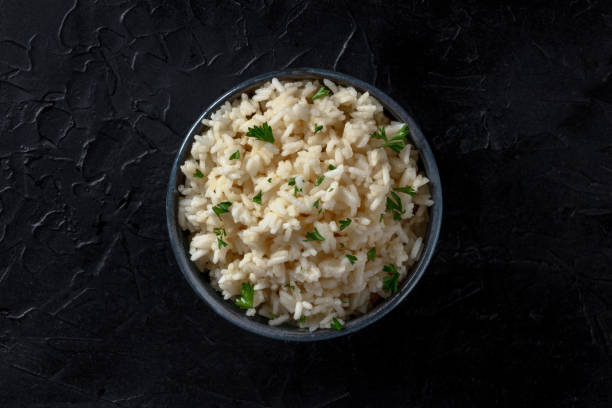 istock Rice in a bowl, overhead shot on a black background 1309013193